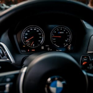a close up of a car's steering wheel and dashboard