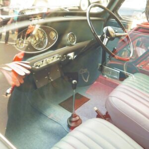 the interior of a car with a steering wheel and dashboard