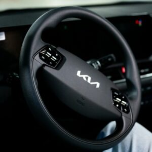 Here is a possible caption: a kia car's steering wheel is visible.