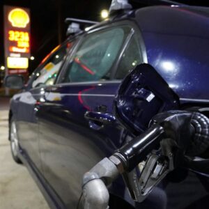 a blue car is parked at a gas station