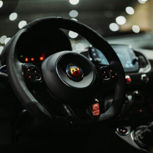 Close-up of a car's steering wheel and dashboard.