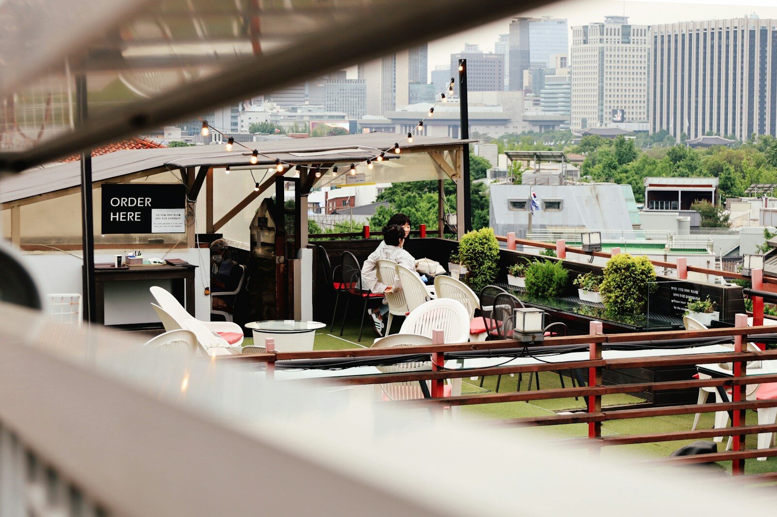 Rooftop cafe with city skyline in background