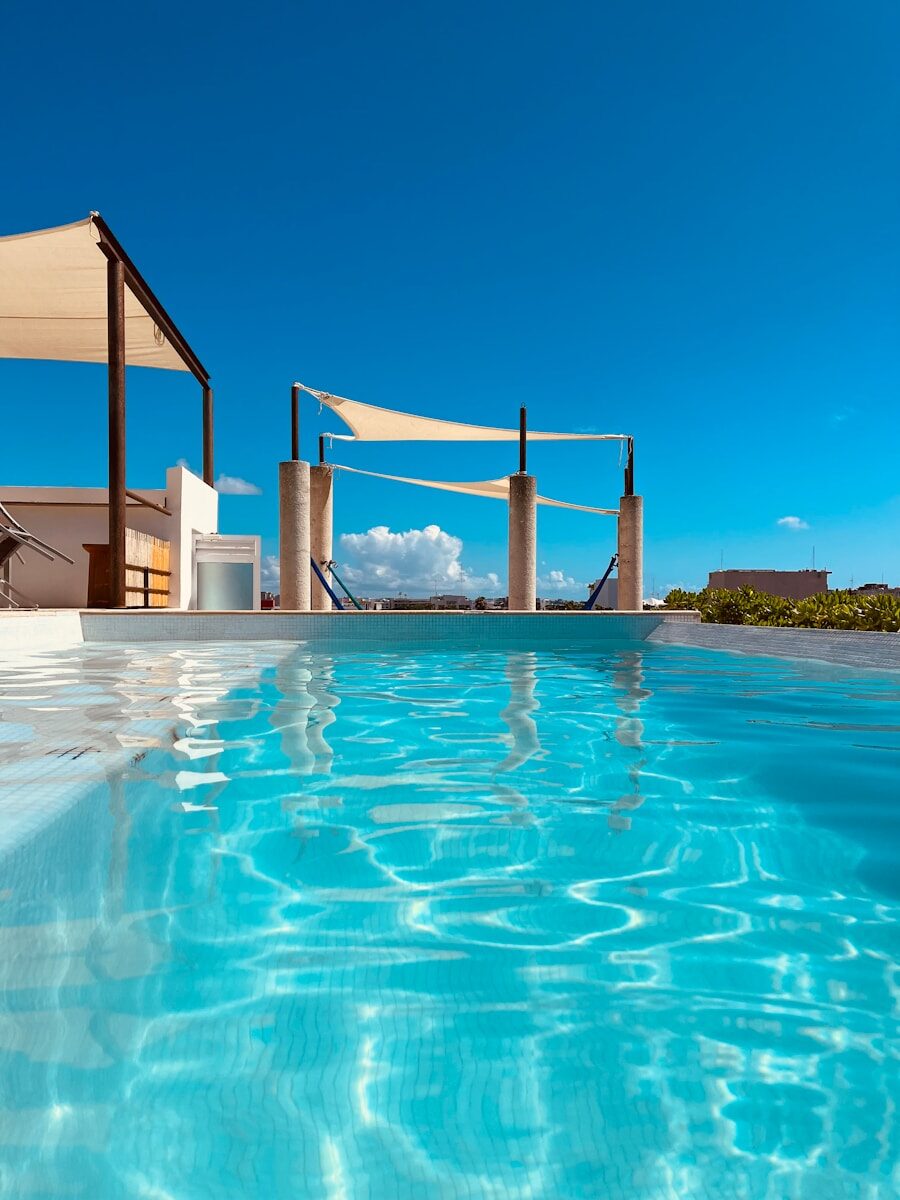 Rooftop infinity pool overlooking a bright blue sky.