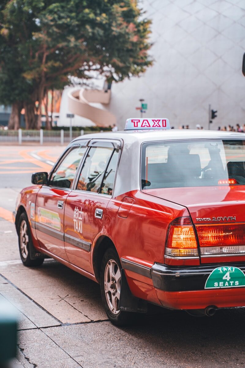 a taxi cab parked on the side of the road