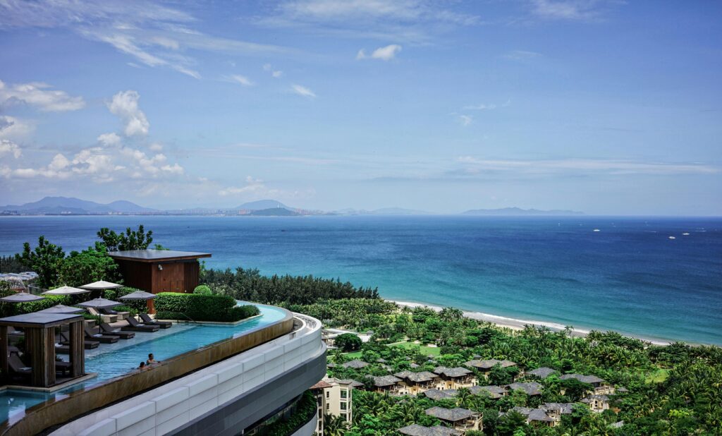 Stunning seaside resort with infinity pool overlooking the tropical ocean landscape.