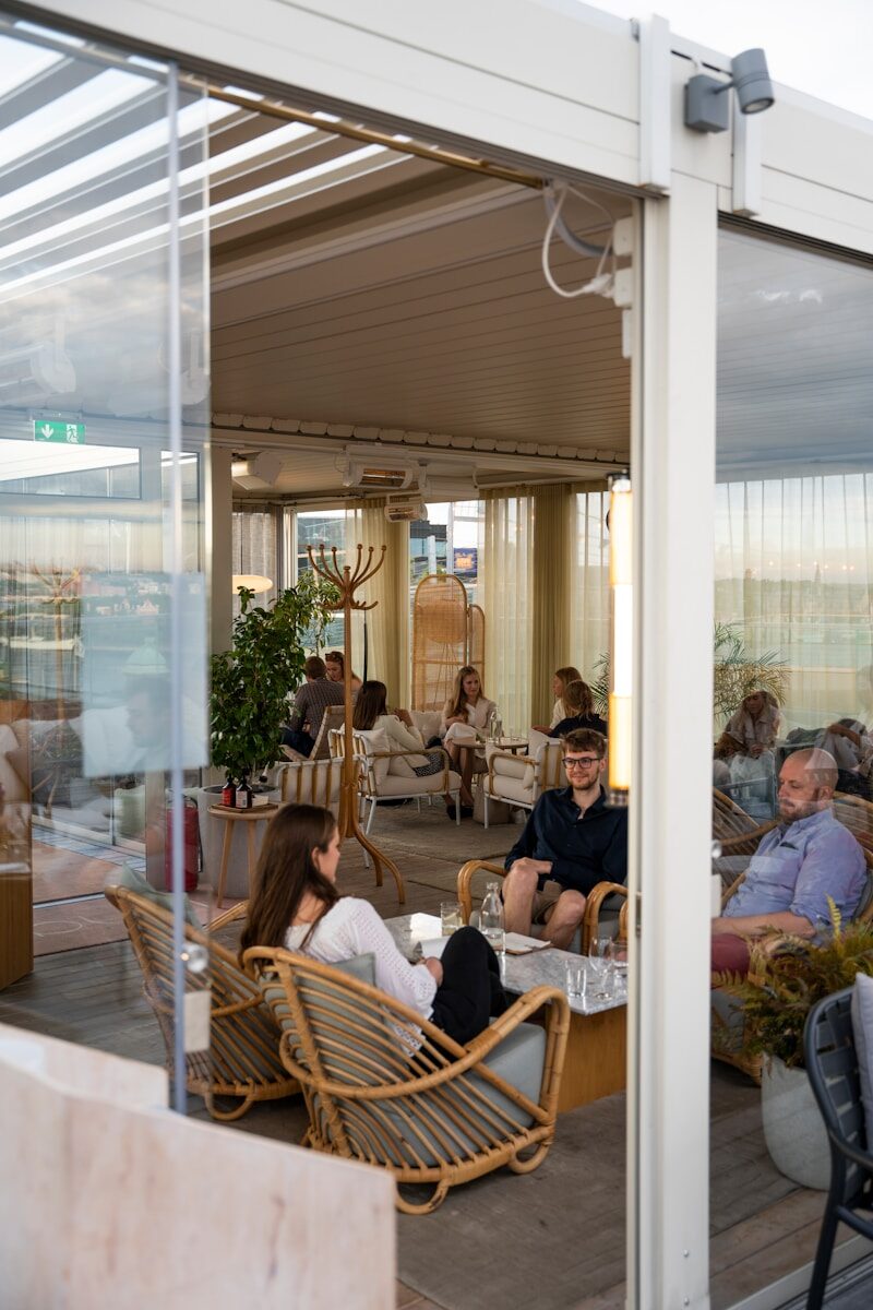 people sitting on brown wooden chairs