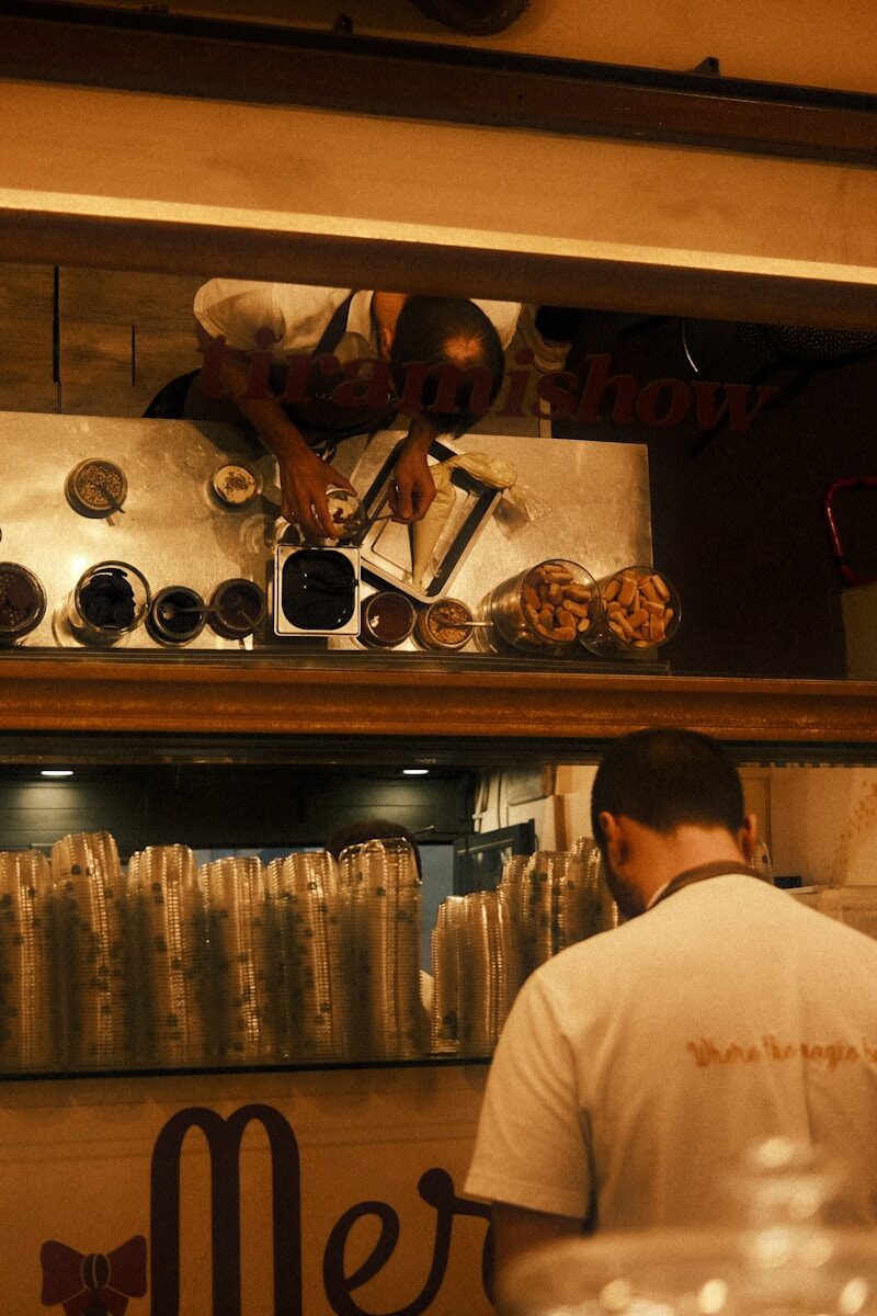 A man working behind a counter in a restaurant